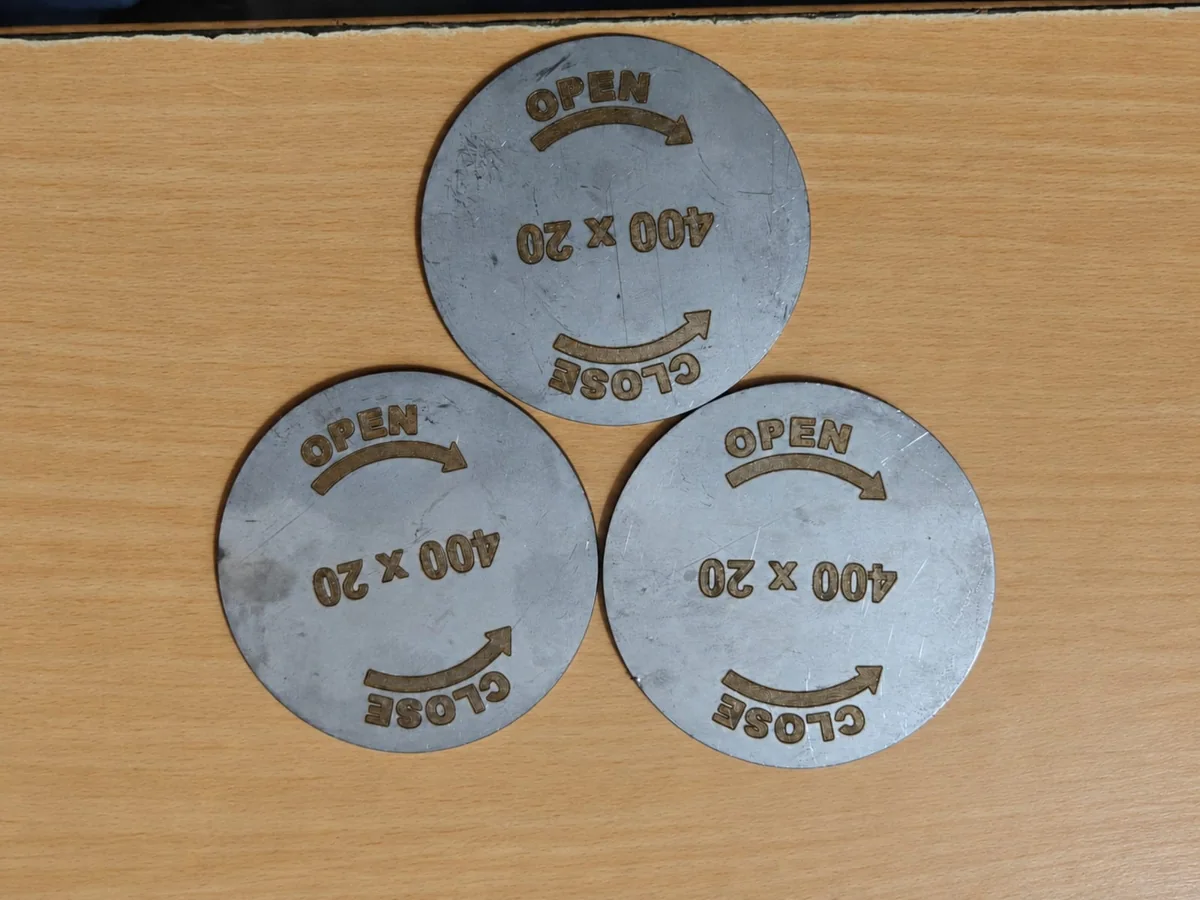 Three metal discs engraved with OPEN and CLOSE arrows and 400 x 20 text