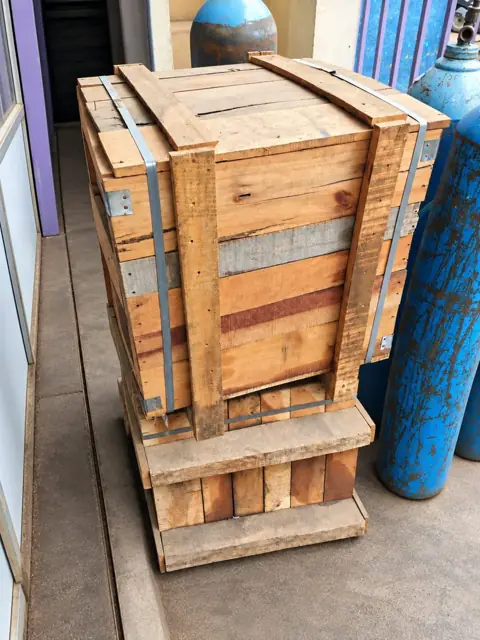 Closed wooden packing crate reinforced with timber and metal straps