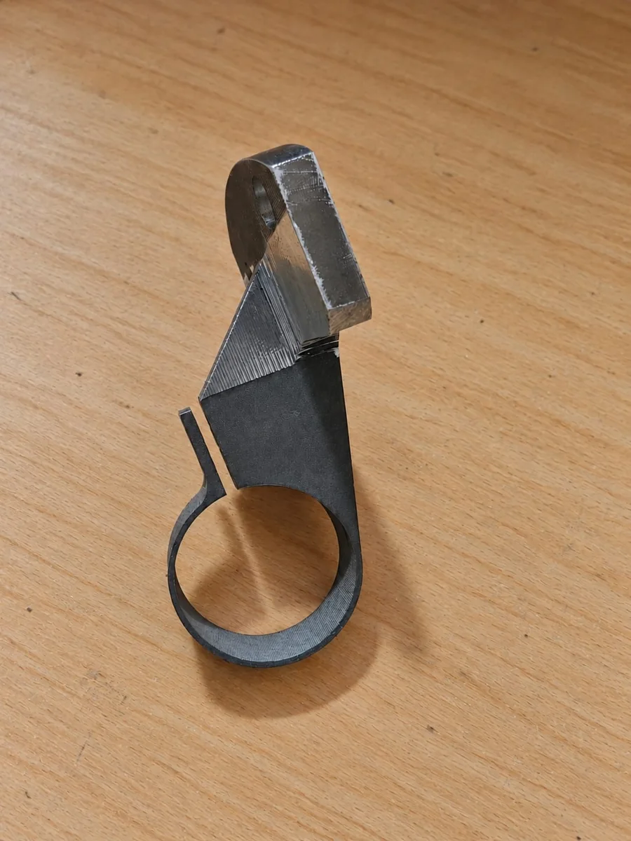 Wire-EDM component with a circular opening and shaped outline